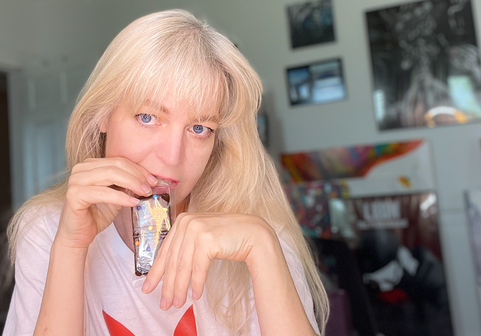 Melissa Whitaker biting into a wrapped cosmic brownie. How to find yourself again