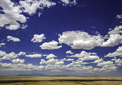 Photograph of clouds in Arizona with mountains on the distant horizon.  Taken by Melissa Whitaker